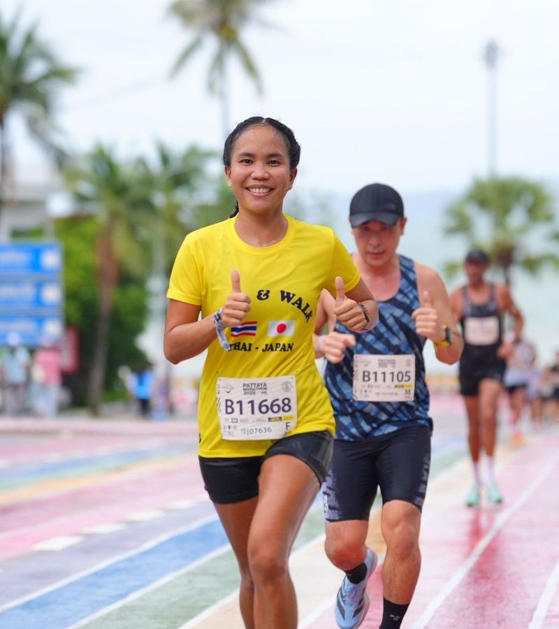 Club runner smiling mid-race at the Pattaya Marathon