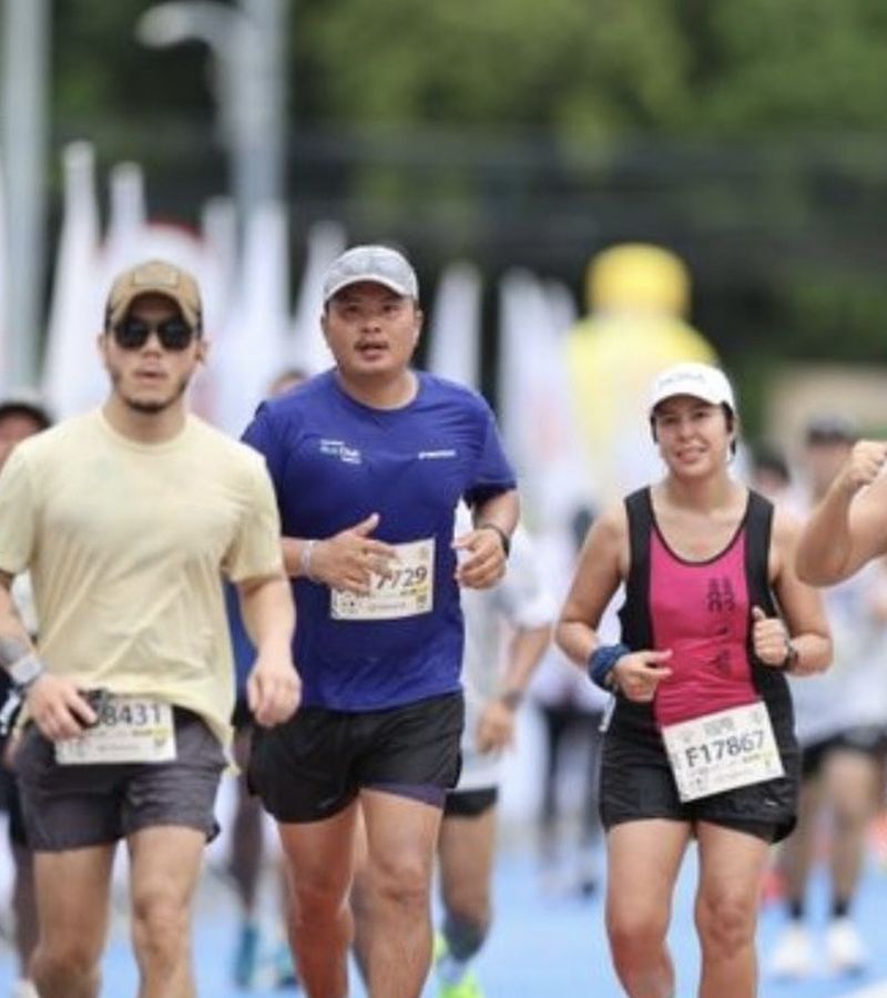 A pack of runners at sunrise on the marathon course